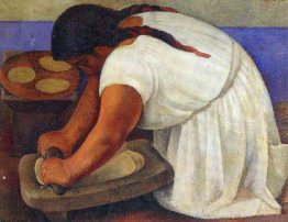 Femme broyant le maïs