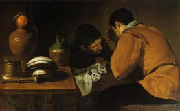 Deux jeunes hommes mangeant à une humble table