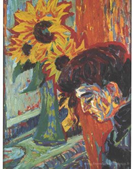 Tête d'une femme devant les tournesols