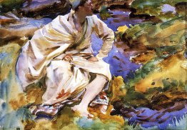 Un homme assis par un ruisseau