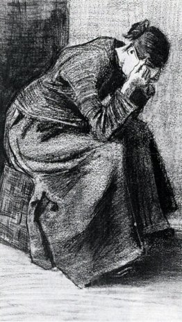 Femme assise sur un panier avec la tête dans les mains
